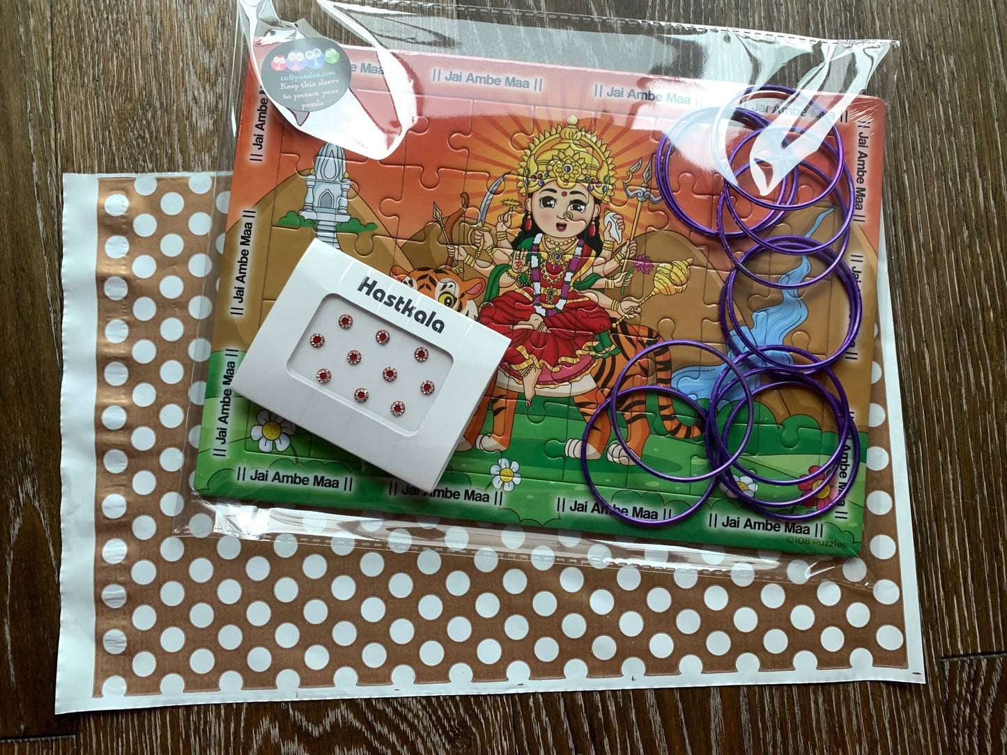 Example of a packaged up Devi puzzle with bangri and chandla as a goyni gift for kids