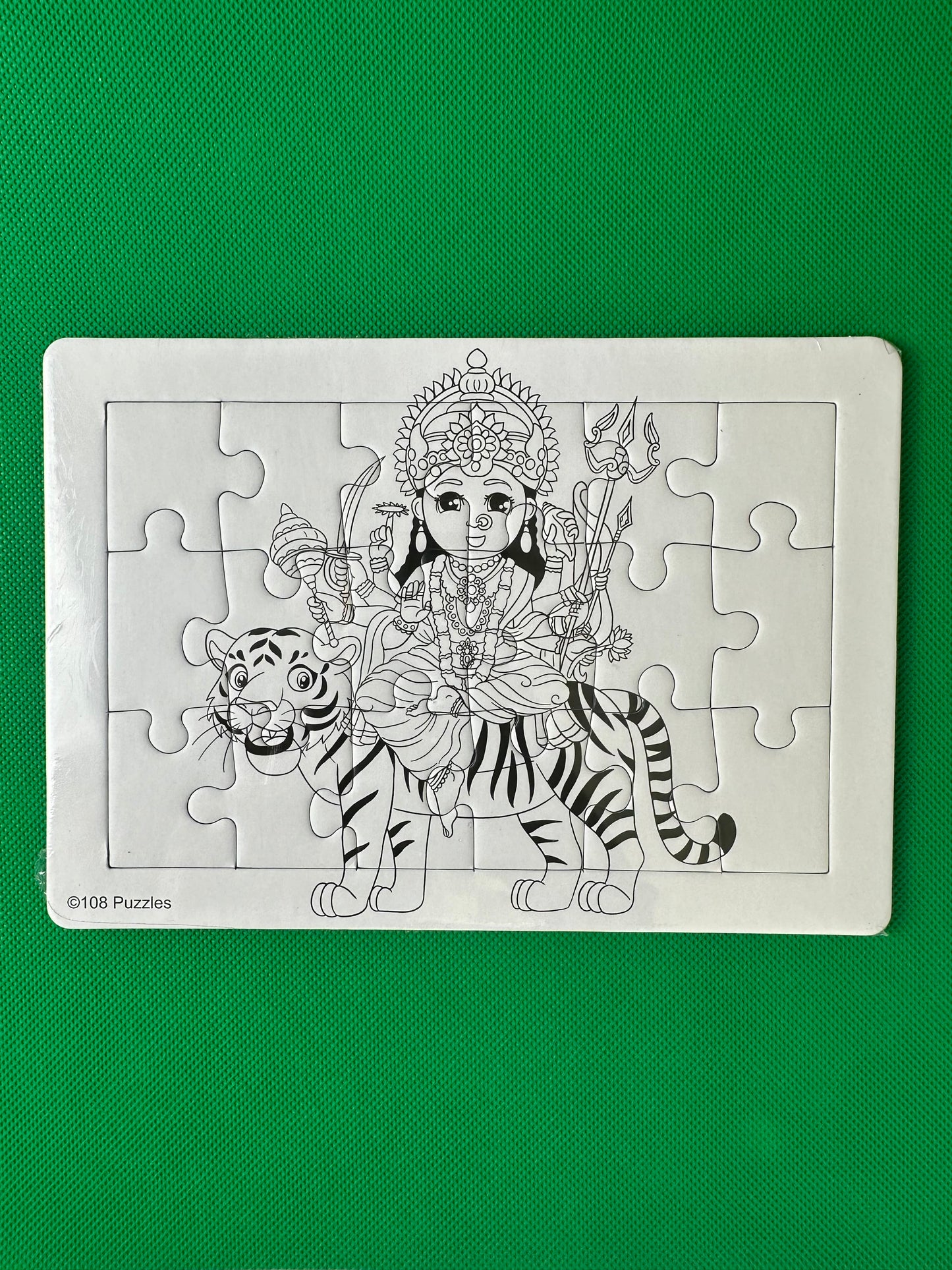 Jigsaw puzzle of Durga on a tiger on a green background