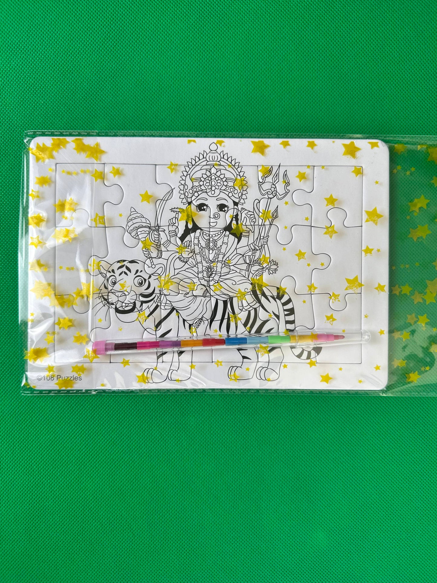 Colouring puzzle of Hindu Goddess Ambe Maa with a colouring crayon on a green backgroud