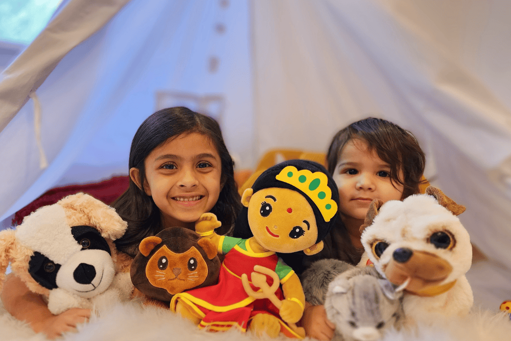 Two children with their favourite plush toys in a cozy indoor setting