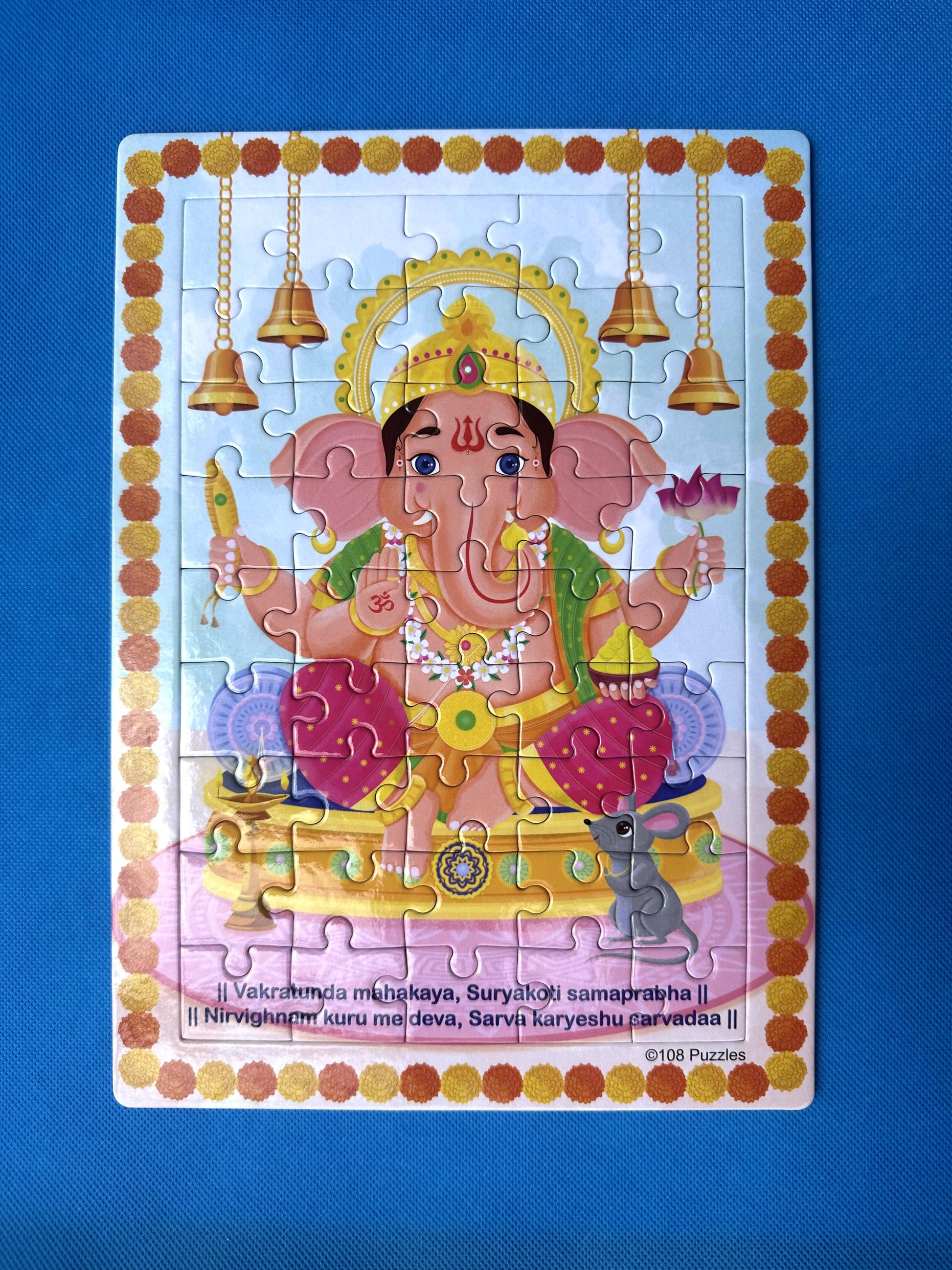Colourful puzzle of Hindu God Ganesha for kids with decorative border on a blue background