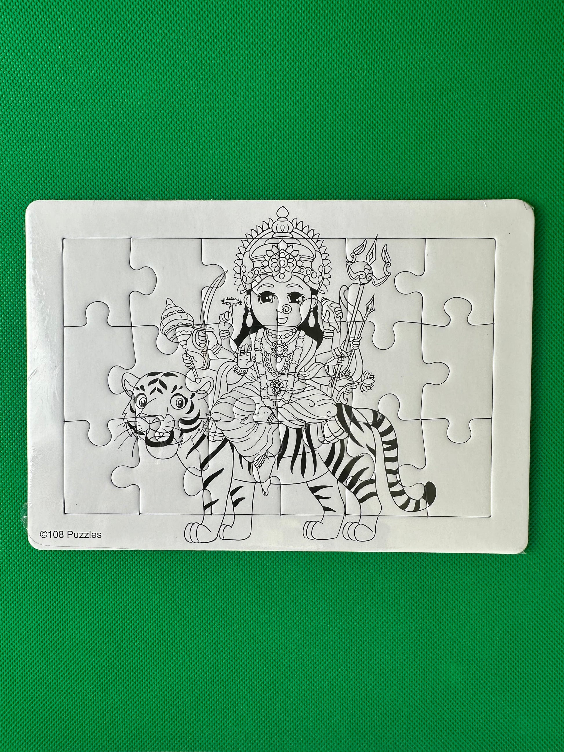Jigsaw puzzle of Durga on a tiger on a green background