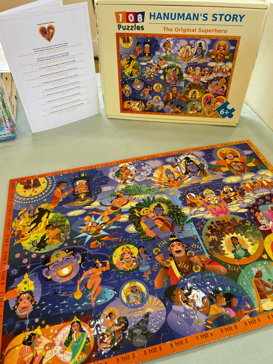 Hanuman's Story puzzle with box and Hanuman Chalisa translation on a table
