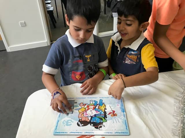Two children solving the Ganesha Shiva puzzle together and learning about Hindu mythology