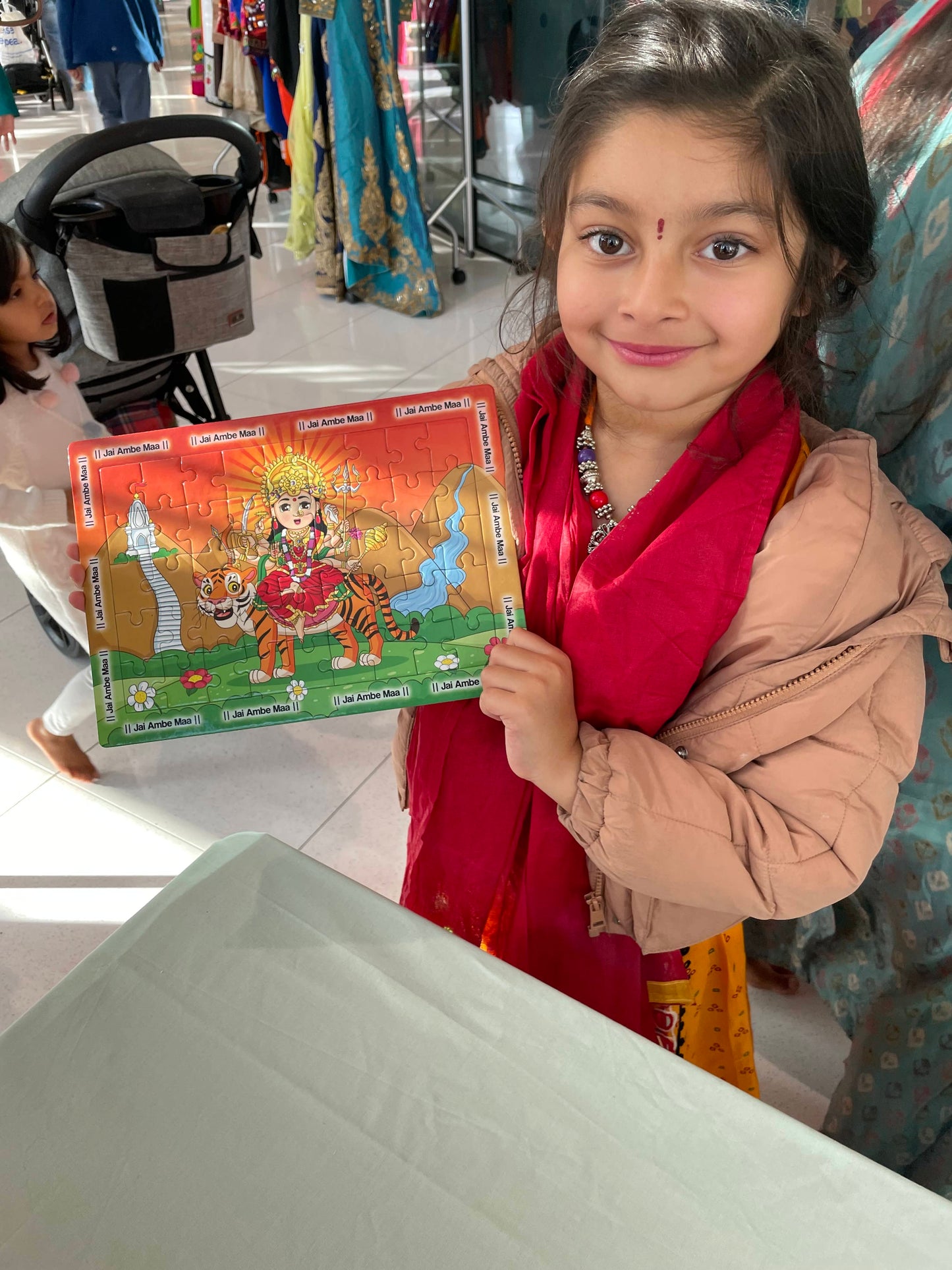 Delighted Hindu child after completing the Mataji jigsaw puzzle to celebrate Navratri