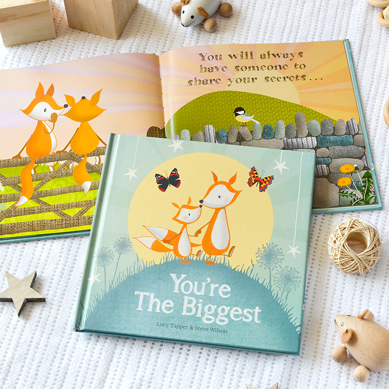 Children's book titled 'You're The Biggest' with a fox illustration on a textured surface.