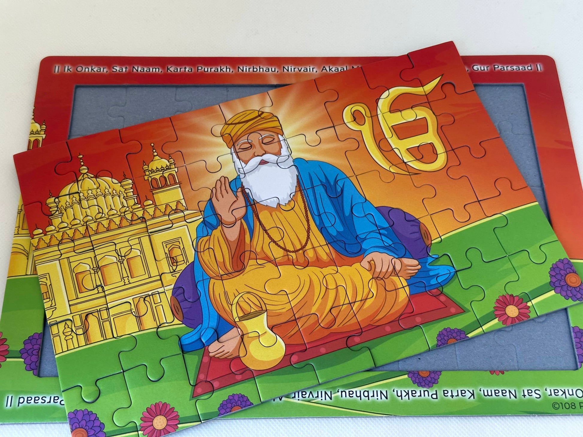 Jigsaw puzzle of Guru Nanak and the golden temple with the mool mantra in the border