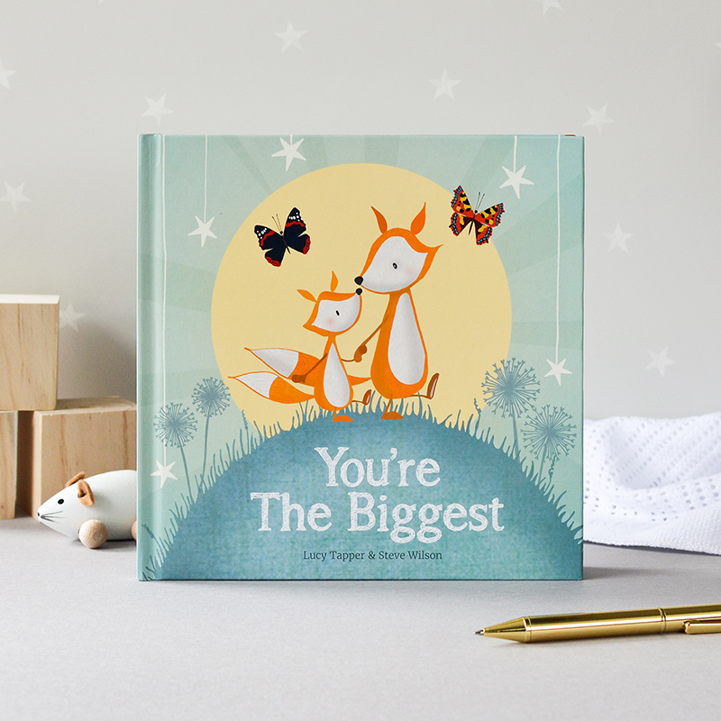 Children's book titled 'You're The Biggest' with fox illustrations on a light gray surface.