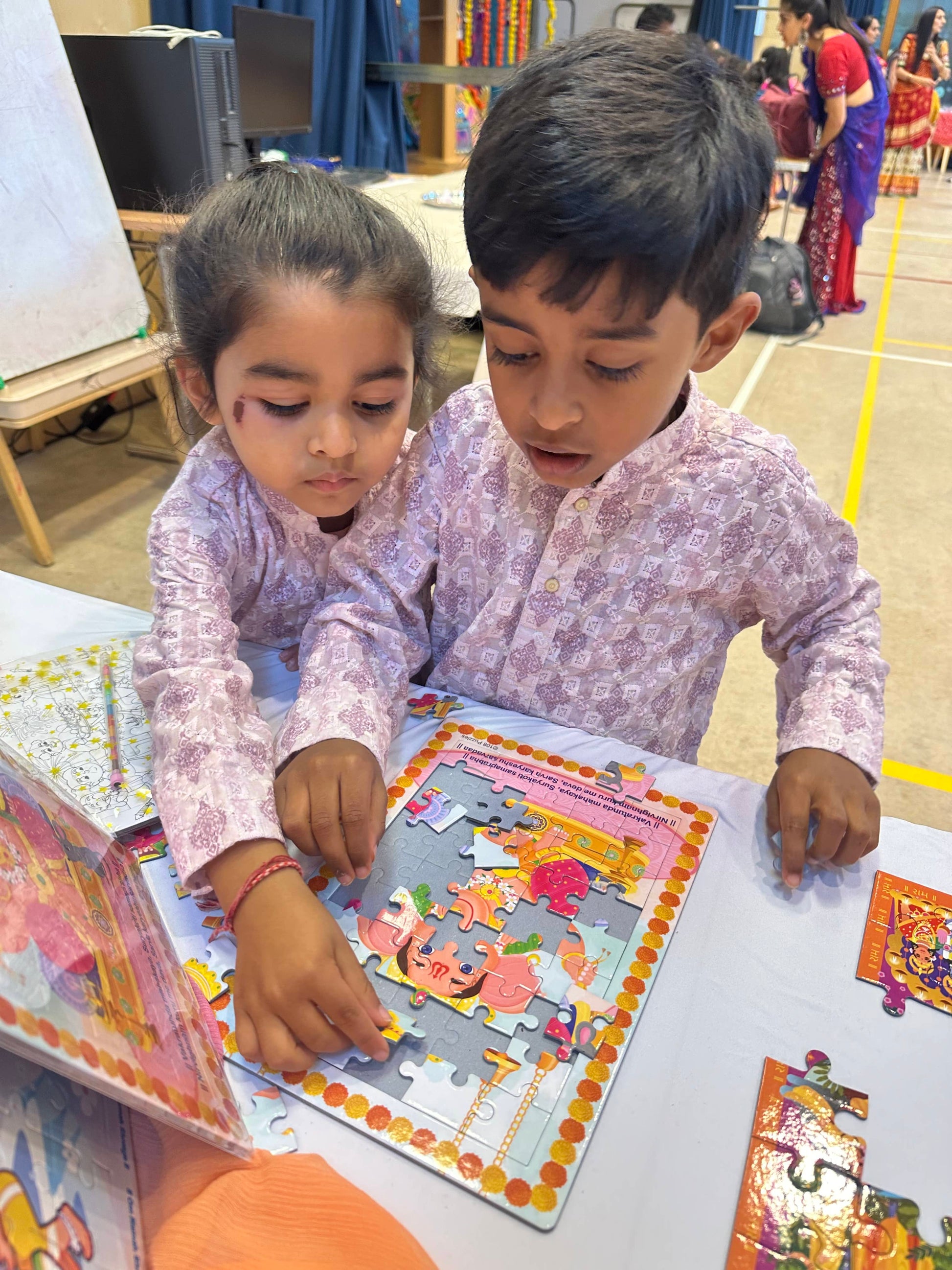 Two brothers working on a puzzle at a table during Navratri