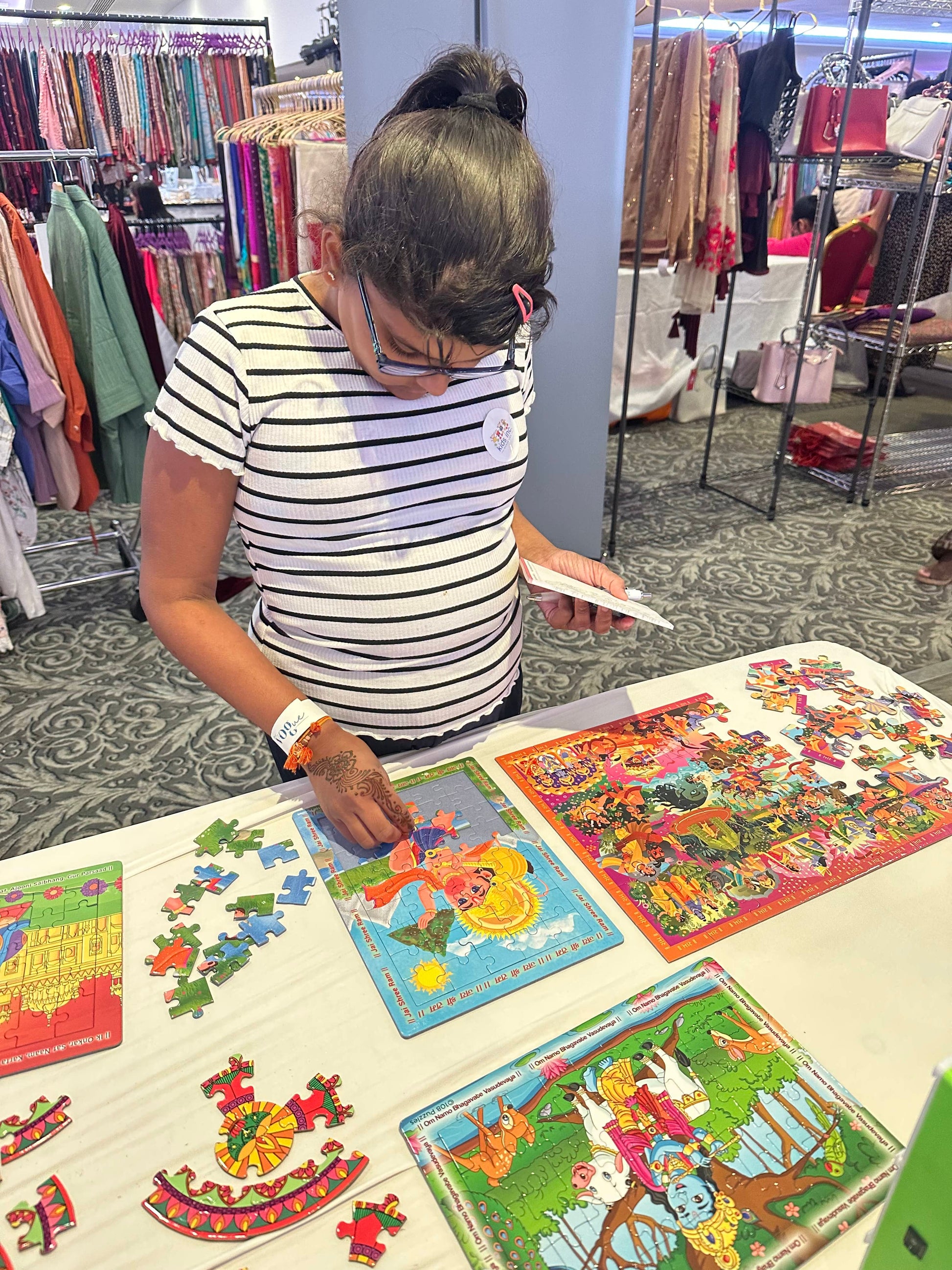 kid showing the Hanuman puzzle in action on a table of puzzles