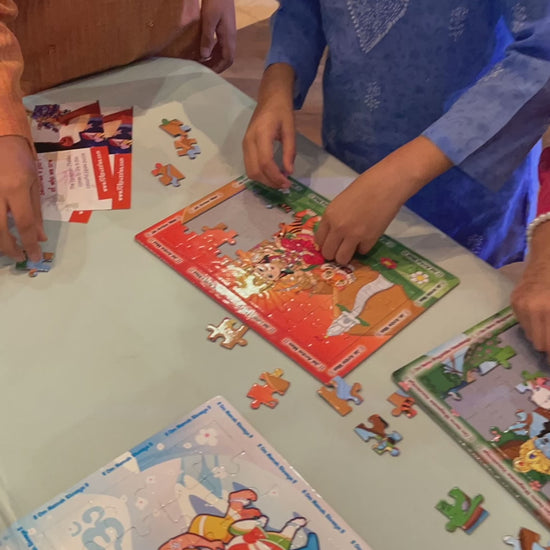 Children Navratri activity finishing the Ambe Maa jigsaw puzzle