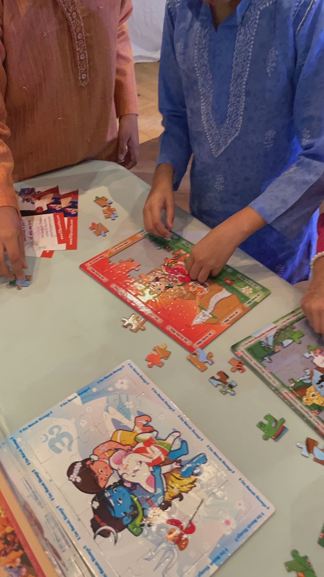 Children Navratri activity finishing the Ambe Maa jigsaw puzzle