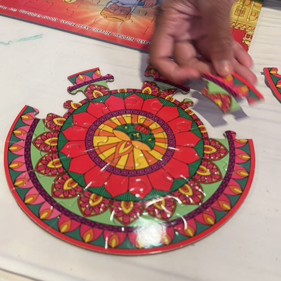 Girl piecing together rangoli puzzle at  Diwali event
